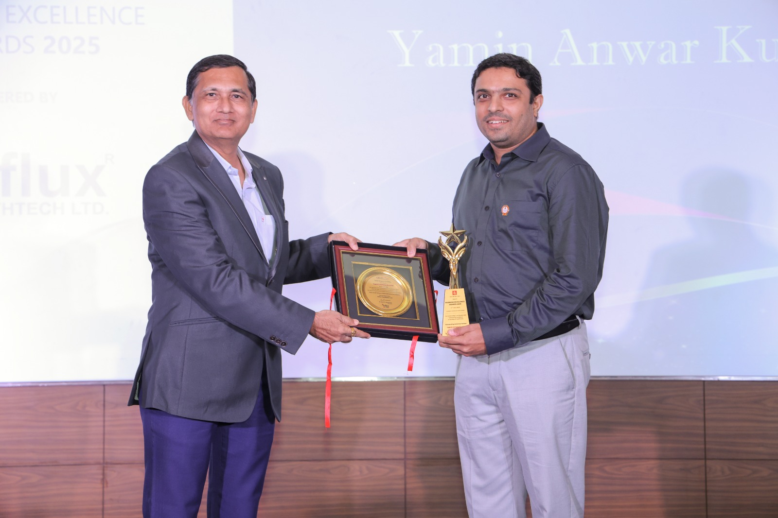 Mr. Nilesh Gandhi presenting 'Outstanding Associate Partner' award to Yamin Anwar Kunda